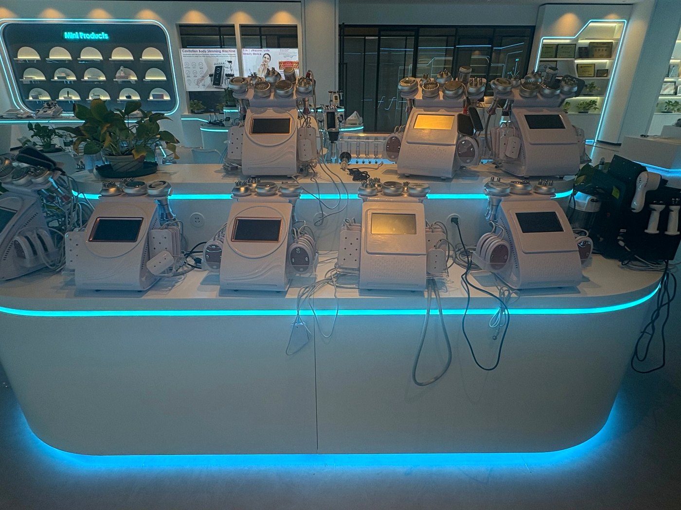 SaintQueen™ showroom display of professional beauty equipment with ambient LED lighting